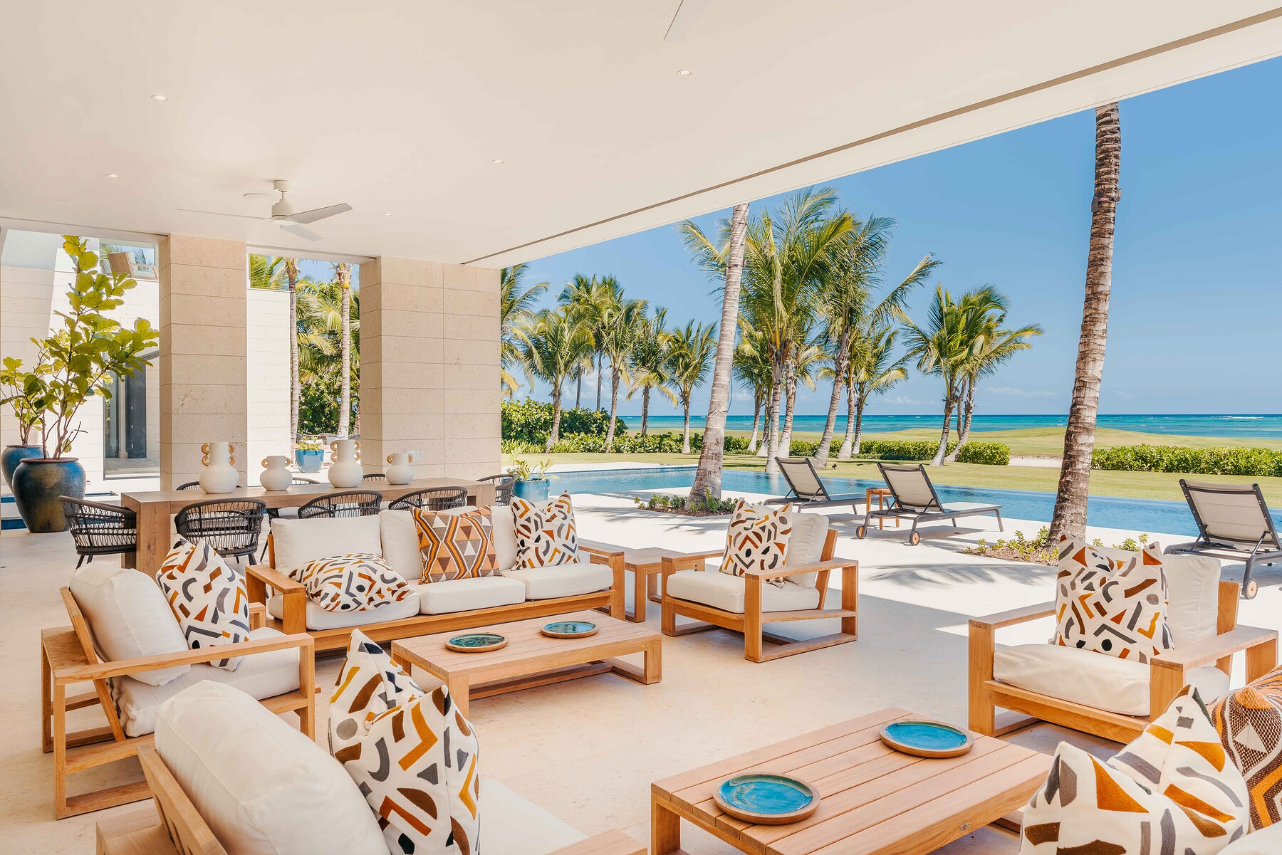 Villa at a Punta Cana resort — open-air terrace with custom furniture and ocean view by SOMMA